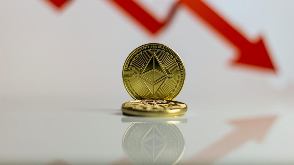 pexels-photo-10468098-10468098 Close-up of Ethereum cryptocurrency with red downward arrow, symbolizing market decline.