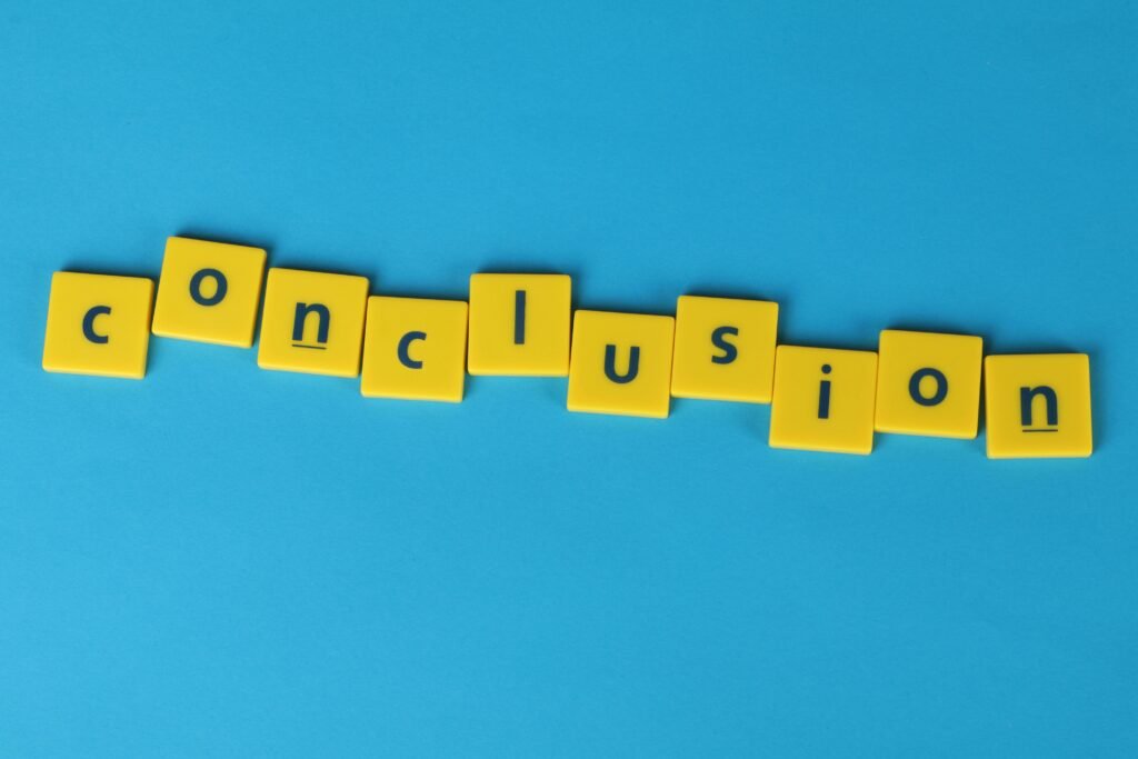 pexels-photo-1888005-1888005 Yellow letter tiles spelling 'conclusion' on a vibrant blue background emphasizing creativity and achievement.