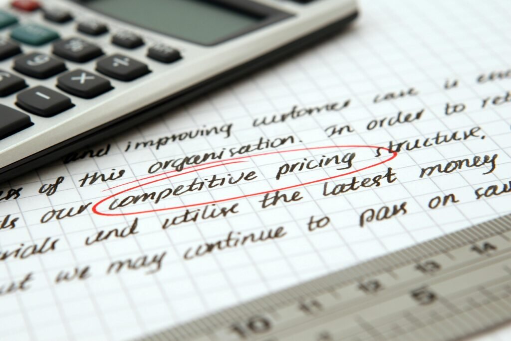 pexels-photo-262470-262470 Focused image of handwritten business notes with calculator emphasizing pricing strategy.