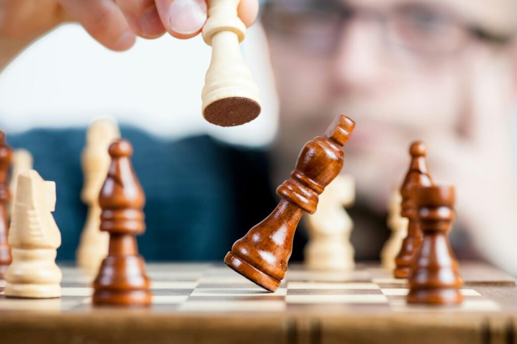 pexels-photo-277124-277124 Close-up of a chess game with a focused player, emphasizing strategy and competition.