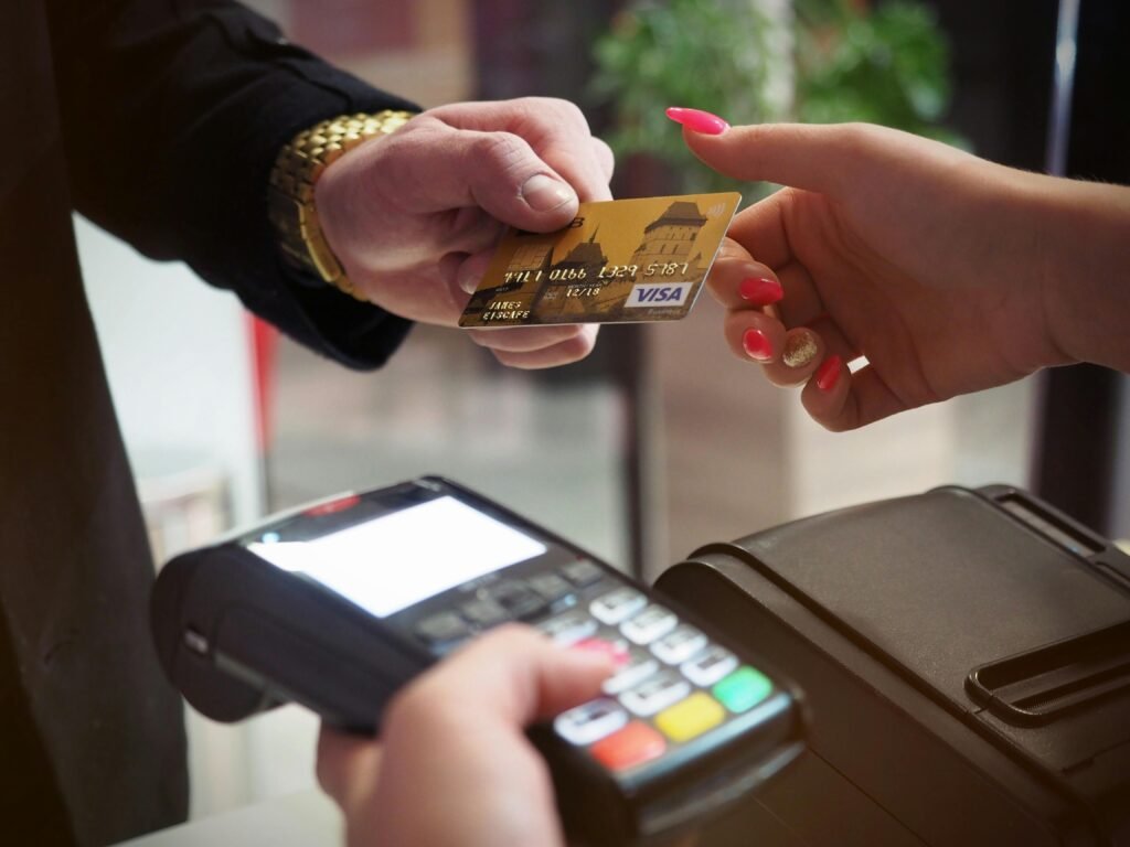 pexels-photo-2988232-2988232-1 Close-up of a credit card payment being processed at a POS terminal.