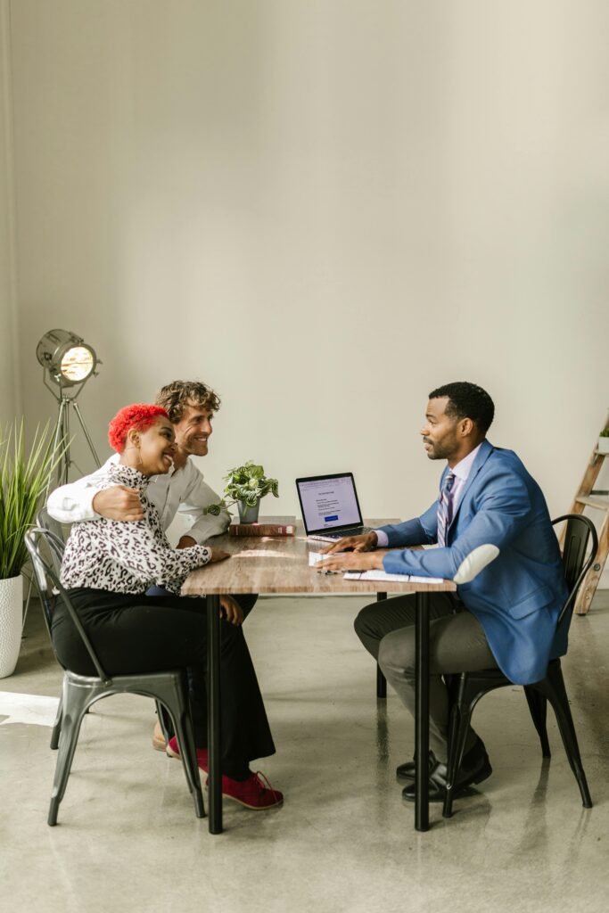 pexels-photo-7821911-7821911 A professional financial advisor discusses options with a couple in a modern office setting.