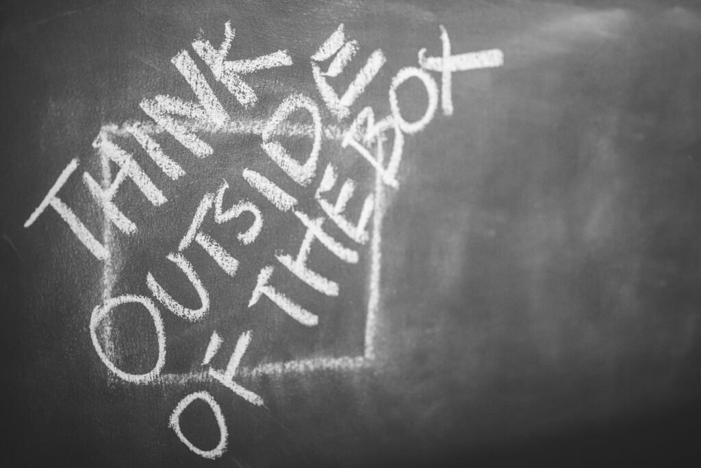 quote-chalk-think-words-6375 Chalkboard with 'Think Outside the Box' handwritten, inspiring creativity.