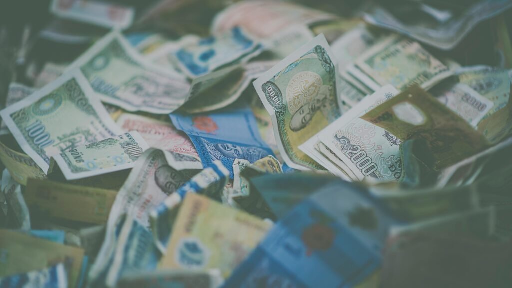 pexels-photo-1629172-1629172 A close-up view of diverse international currency banknotes in soft focus, conveying wealth and finance themes.