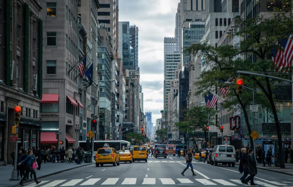 pexels-photo-378570-378570 Vibrant street view of New York City with pedestrians, yellow cabs, and skyscrapers.